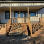 A wooden porch featuring steps and a railing, showcasing a rustic and inviting outdoor space.