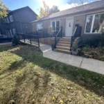 A house featuring a front porch with steps leading up to the entrance door.